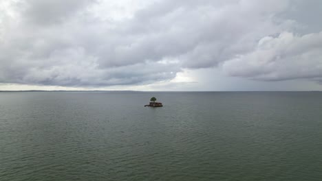 Drone-shot-of-small-abandoned-house-in-the-middle-of-the-ocean