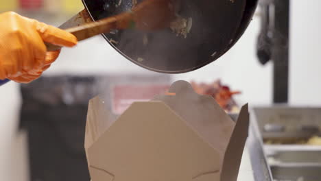 restaurant cook boxes up to go take out order of fried rice, slow motion 4k