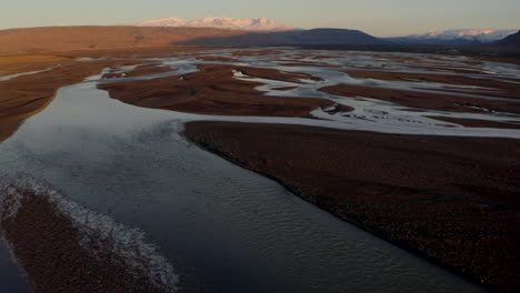 Toma-Aérea-Panorámica-Sobre-Los-Ríos-Trenzados-De-Islandia-Hacia-Las-Montañas-De-Las-Tierras-Altas