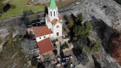 Aerial:-flying-over-a-chappel-in-the-catalan-countryside-in-Spain