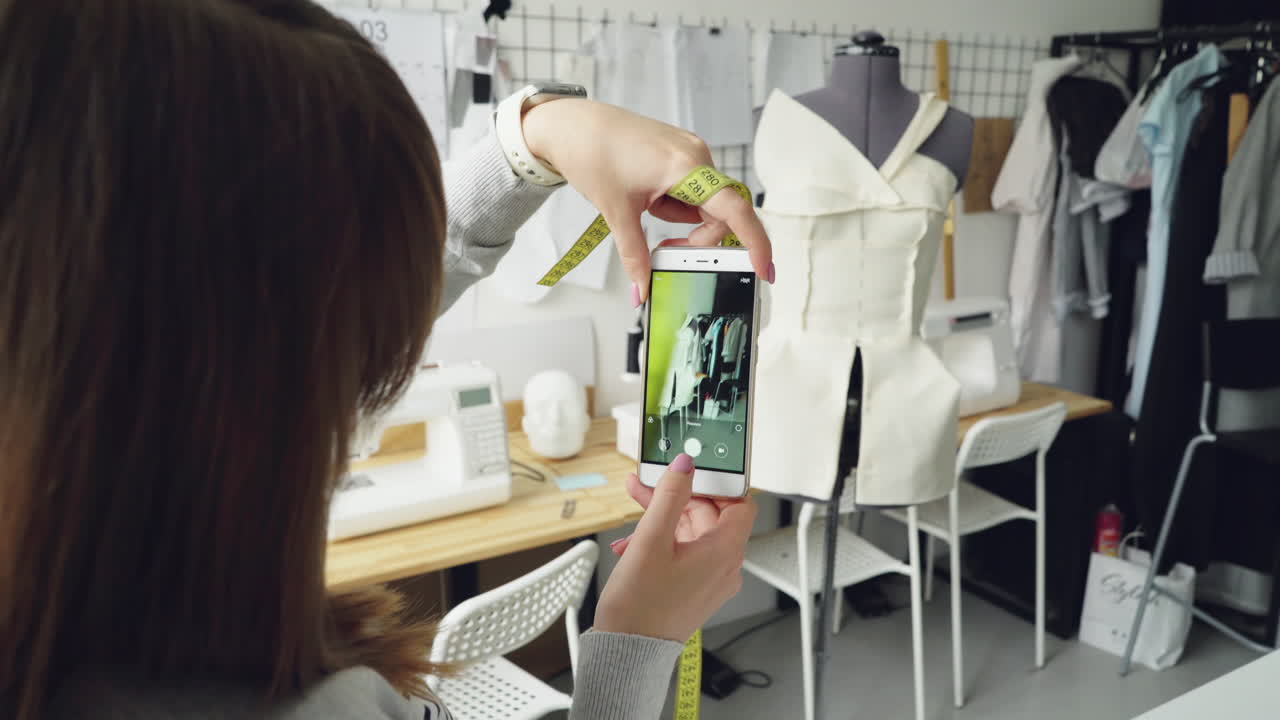 Fashion Designer Taking Photo of a Prototype Dress