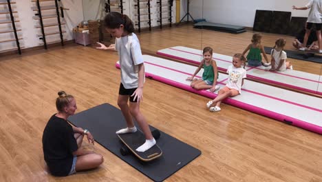 children learning balance on balance boards