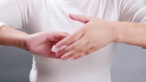 Young-woman-performing-self-hand-massage-during-break-in-office