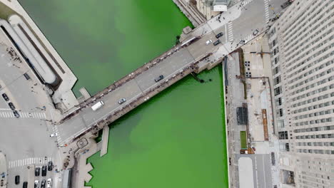 aerial view of dyed river water in middle of skyscrapers, st