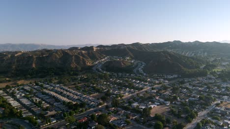 aerial flyover of a unique neighborhood in santa clarita, sunrise in california