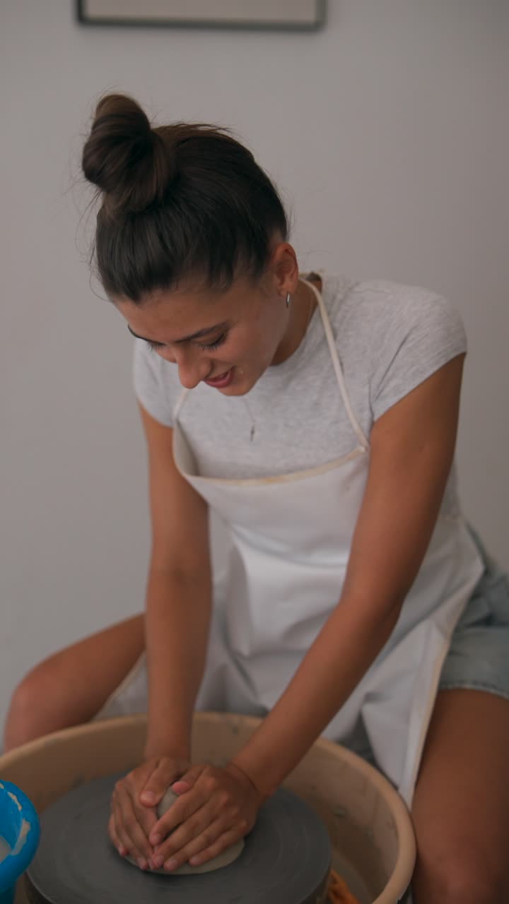 Young Woman Crafting Pottery on a Wheel