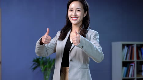 Head shot of cheerful businesswoman gives two thumbs up, like yes agreement advice female happy girl business approval employer recommend office good result support sign smiling gesture indoor leader