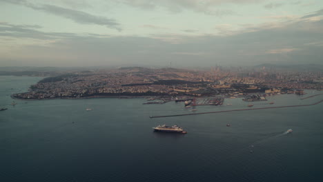 Drone-view-of-ships-docked-in-harbor-in-Istanbul-city-with-cloudy-sky,-Türkiye