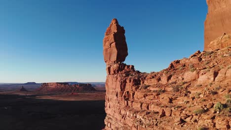 Aerial-pass-by-balancing-rock-to-reveal-Utah-desert-at-sunset