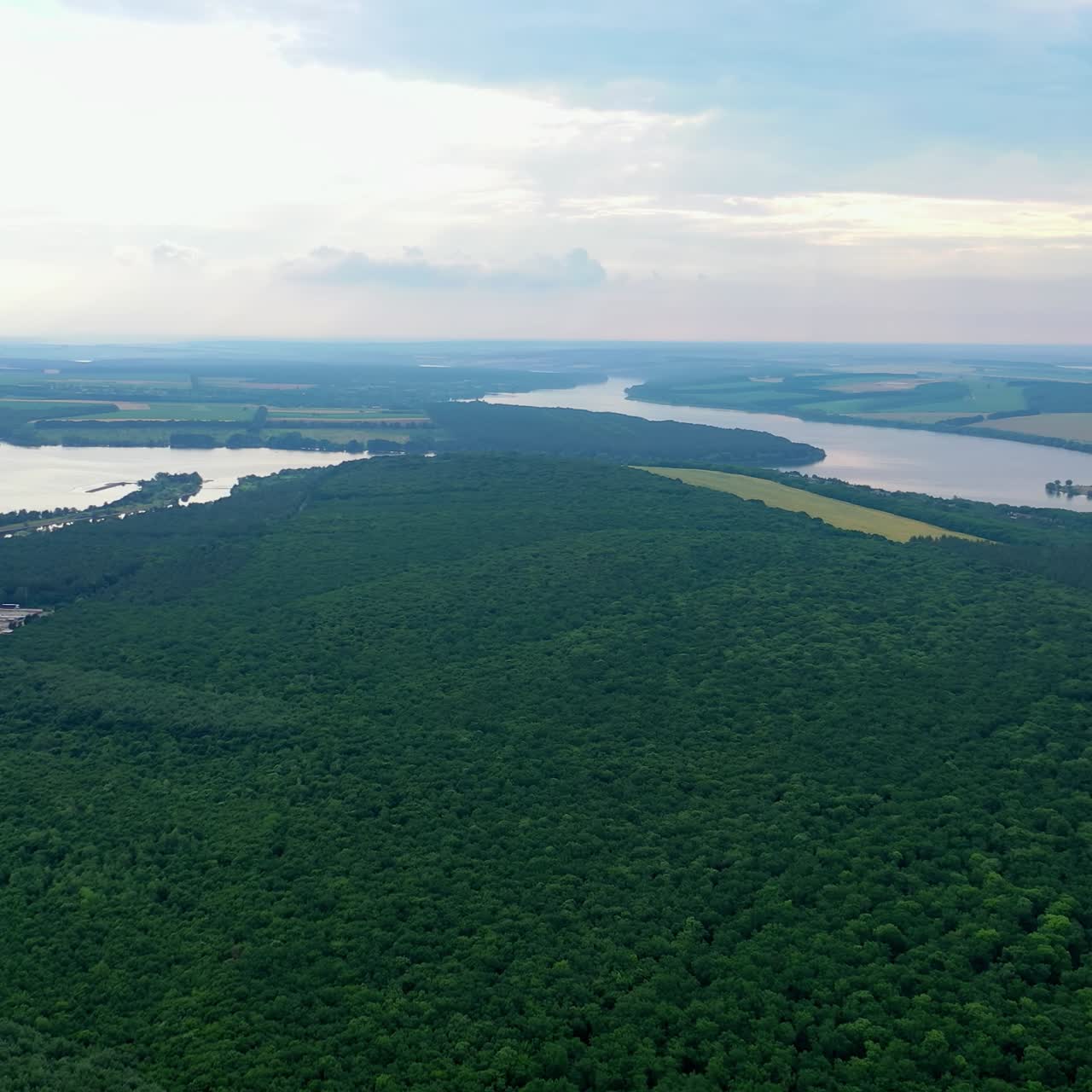 Beautiful green scenery near the river in the evening. Amazing natural background in the countryside. Environmental reserve. Aerial view