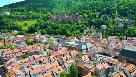 4k aerial drone video of historic homes with castle on königstuhl hill overlooking heidelberg, germany