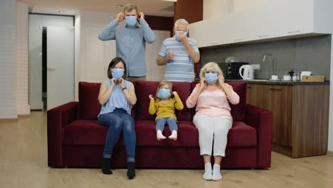 Coronavirus-quarantine-lockdown-concept.-Family-puts-medical-protective-masks-on-faces-at-home