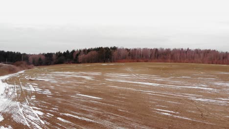 vast and vacant land partially covered with snow in buszkowy gorne, gdansk county, poland