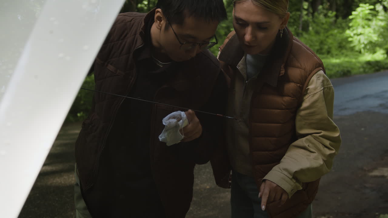 People checking car oil