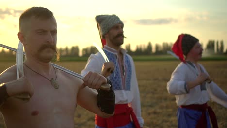 group of cossack men in traditional clothes swinging and spinning sharp shashkas 04