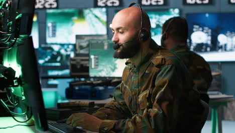 soldier solving tasks in military hq base, gathering information on enemy troops