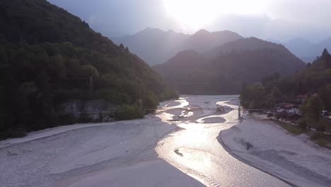 majestic sunset reflection on water of barcis lake in alps, aerial drone view