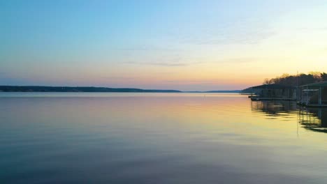 quiet and pristine water of grand lake o' the cherokees at sunset in oklahoma with floating docks