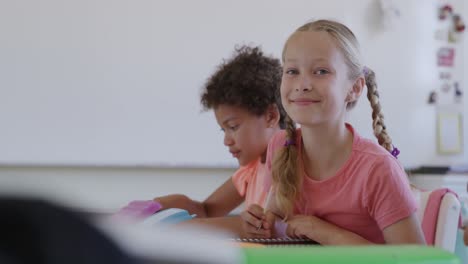 girl smiling while studying in the class