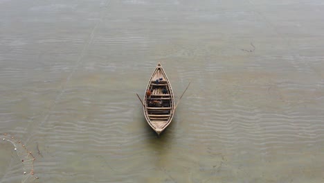 aerial shot of a lonely wooden fishing boat on the shore of a beach in bangladesh