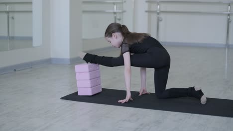 young ballerina practicing dance moves in studio