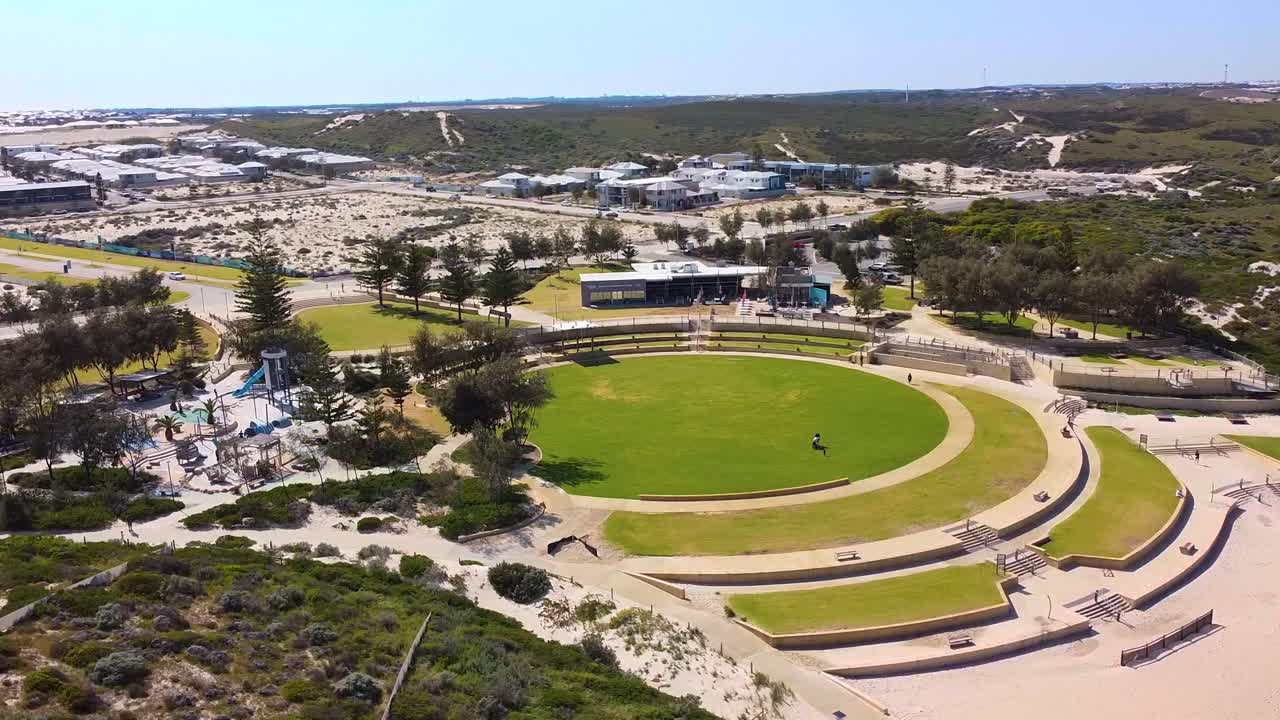 Aerial View of a Coastal Park with Playground and Residential Area