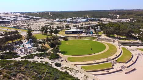 Aerial View of a Coastal Park with Playground and Residential Area