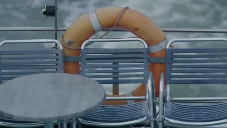 a life preserver attached to the back of a boat sailing on the ocean