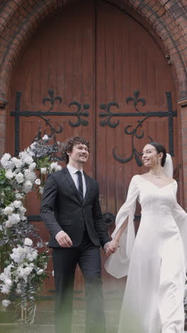 happy couple walking towards church