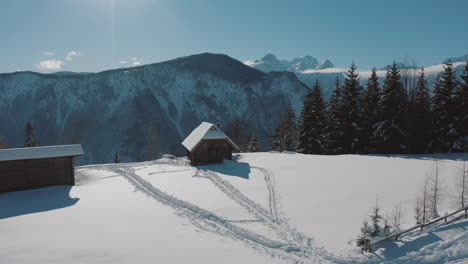 snowy alpine cabin with mountain scenery