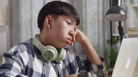 teenager working on laptop