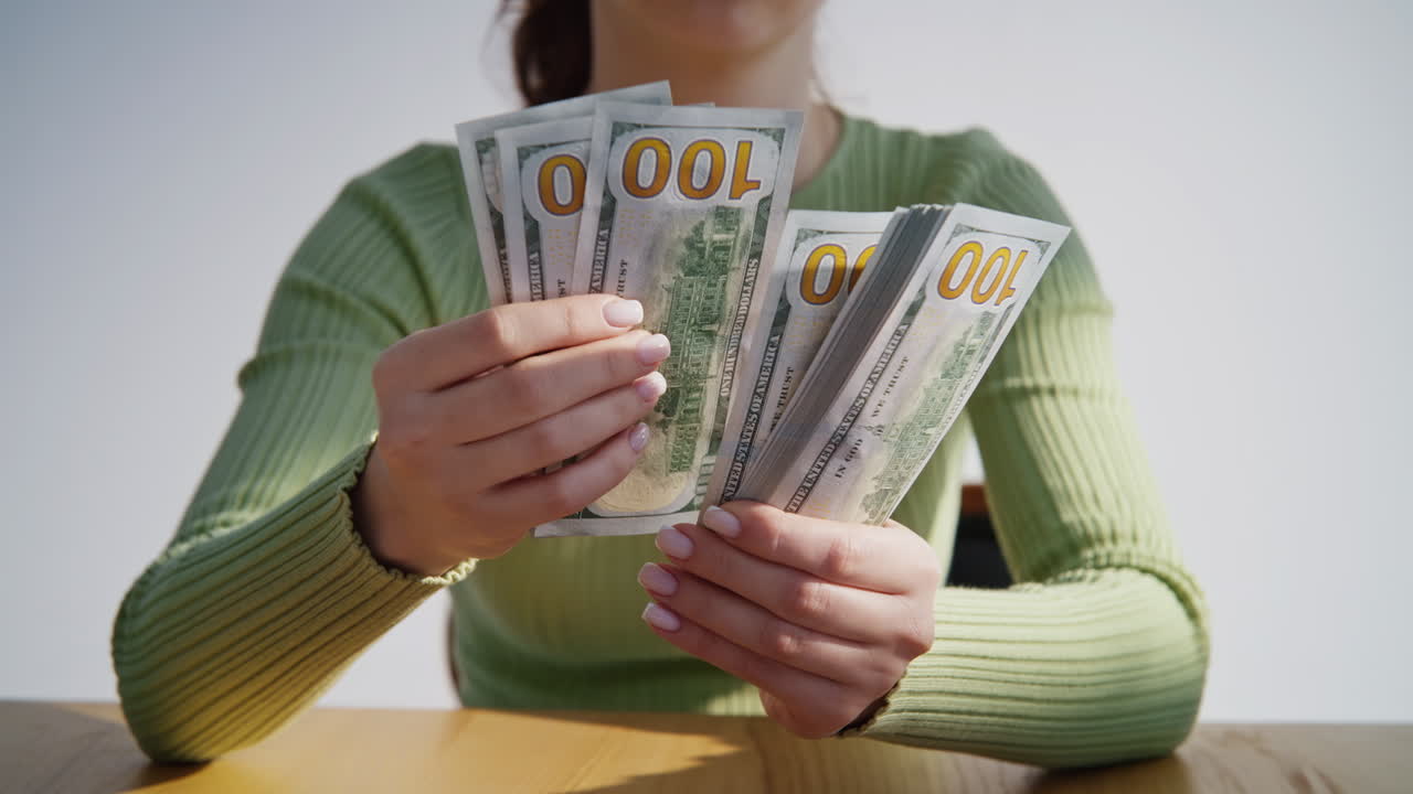 Woman hands calculating dollars denomination of hundred closeup. Counting money
