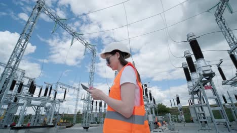 an engineering employee makes a tour and inspection of a modern electrical substation. energy.