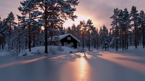 winter cabin in the forest at sunrise/sunset