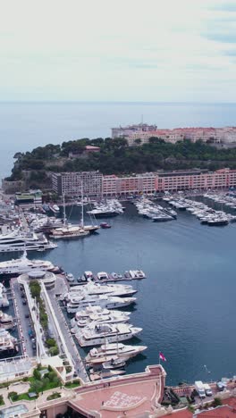 monte carlo, monaco. vertical drone shot of old port, ships, yachts, sailboats and waterfront riviera buildings