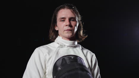 fencer in white uniform with sword