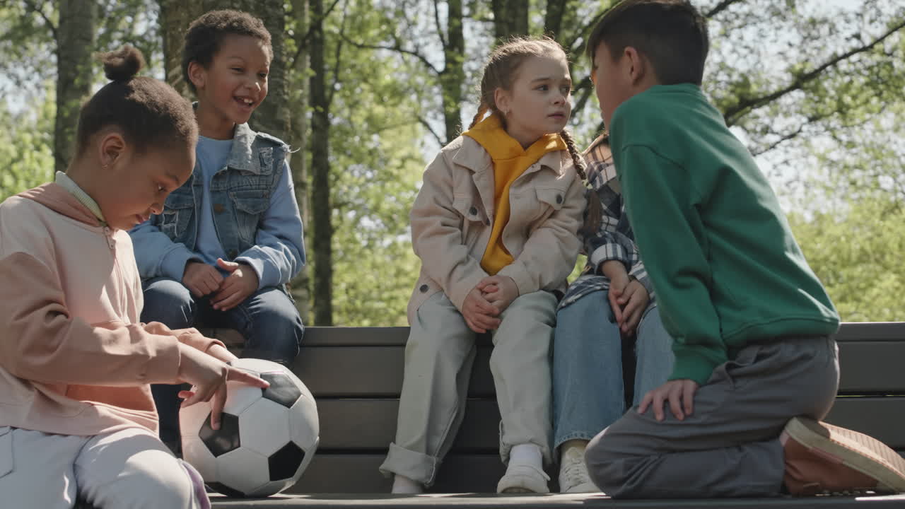 Group of Children Chatting in Park