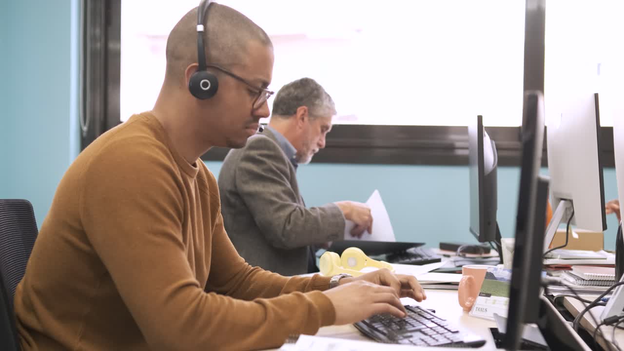 Multiethnic colleagues working on computers in office workspace