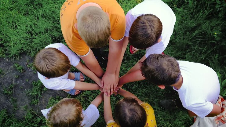 Children keep their hands together. Selective focus.
