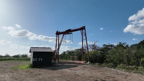 Fixed-crane-on-train-track-for-loading-and-unloading-agricultural-products-in-rural-landscape,-Higueral,-La-Romana-in-Dominican-Republic