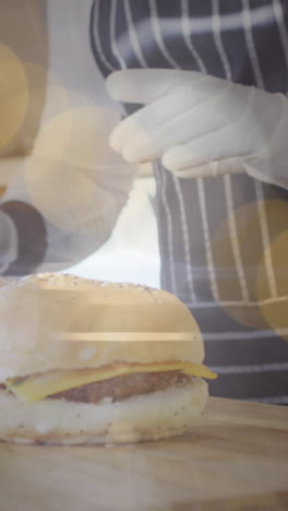 animation of dots over hands of afrcian american man preparing burgers