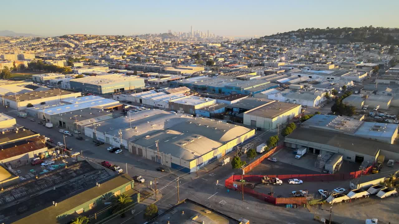 Serene golden hour drone shot capturing an intersection in San Francisco's Bayview neighborhood, with downtown buildings in the background