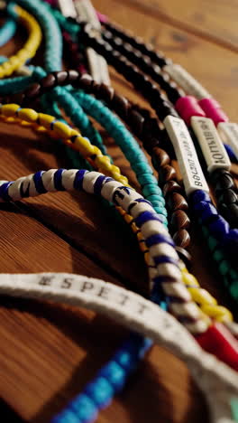 colorful beaded bracelets on wooden table