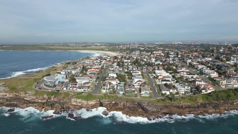 aerial flyover view of ocean front luxury properties and waterfront houses at the sydney coastline