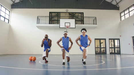 basketball players warming up on court, preparing for intense practice session