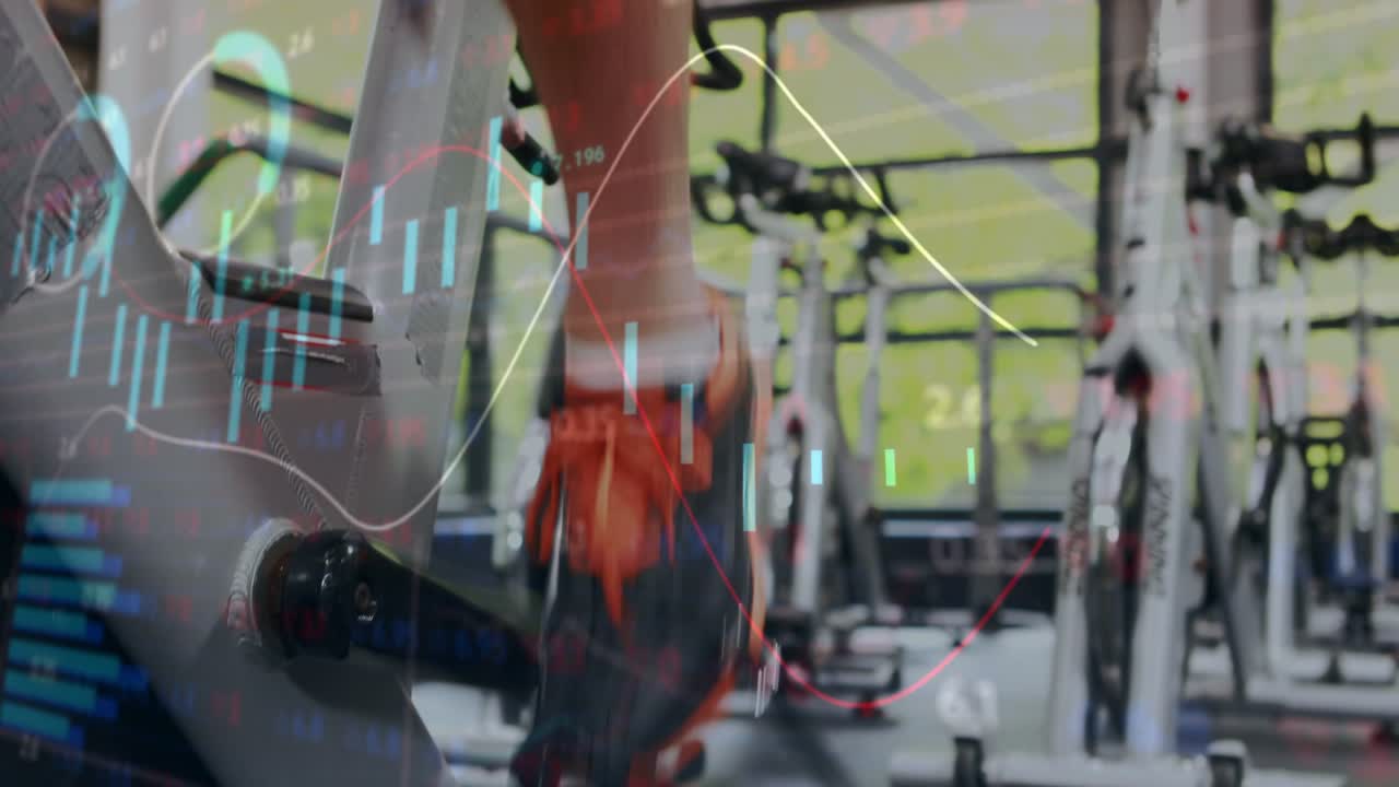 Male cyclist pedaling spin bike in gym, finance charts appearing, tracking power boosting effort