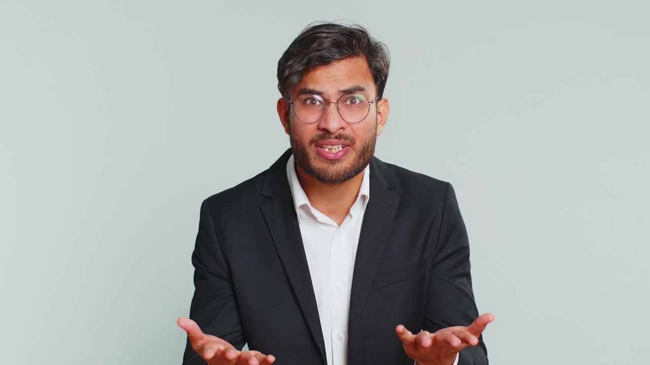 Confused business man pointing at camera showing stupid asking for insane crazy bad plan bullying