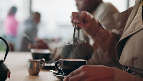 woman, hand and pouring of black tea in cafe to