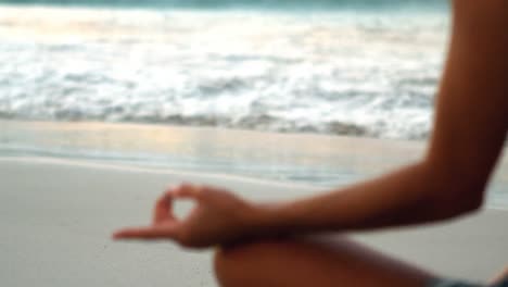 Woman-performing-yoga-on-beach-