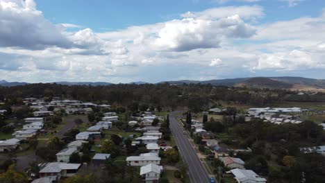 drone ascending over an australian country town with the main road below